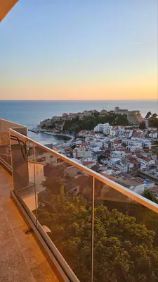 a balcony with a view of a city and the ocean at Apartments Radoman in Ulcinj