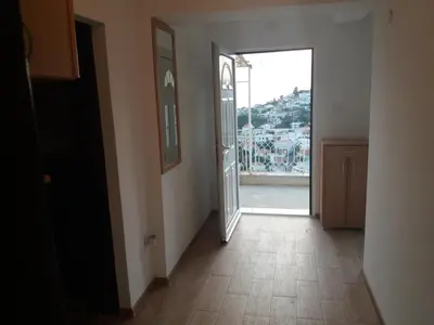 an empty hallway with an open door with a view at Apartments Radoman in Ulcinj