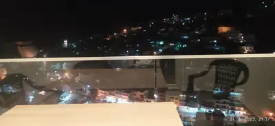 a view of a city from a window at night at Apartments Radoman in Ulcinj