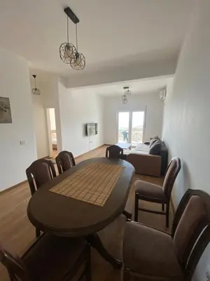 a living room with a table and chairs and a couch at Apartments Radoman in Ulcinj