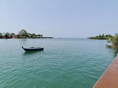 a small boat in the water near a dock at Holiday Home Kite House in Ulcinj