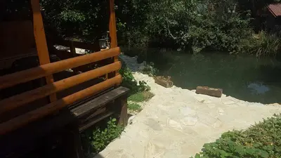 a wooden bench sitting next to a body of water at Holiday Home Kite House in Ulcinj