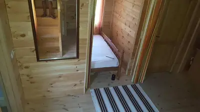 a small room with a bed and a mirror at Holiday Home Kite House in Ulcinj