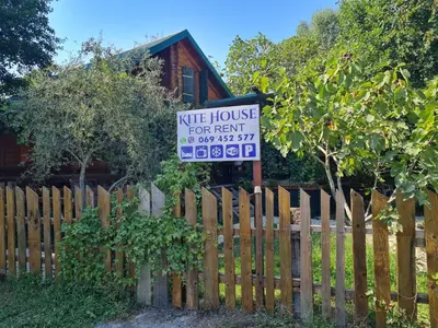 a sign on a fence in front of a house at Holiday Home Kite House in Ulcinj