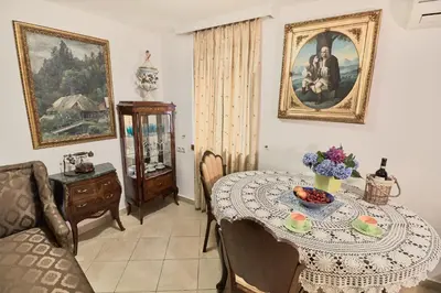 a dining room with a table and a picture on the wall at Apartments Renaissance Old town in Budva
