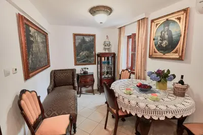 a dining room with a table and chairs at Apartments Renaissance Old town in Budva