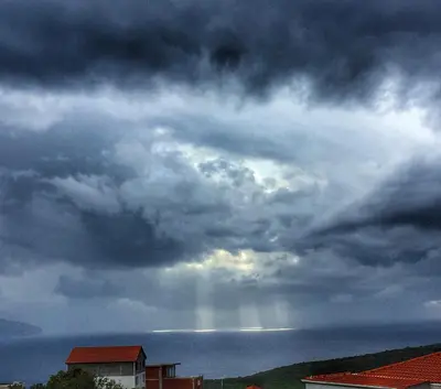 a stormy sky with a rainbow in the sky at Apartments Wild Beauty - Krimovica in Budva