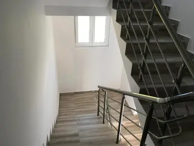 a staircase in a white room with a window at Apartments Wild Beauty - Krimovica in Budva