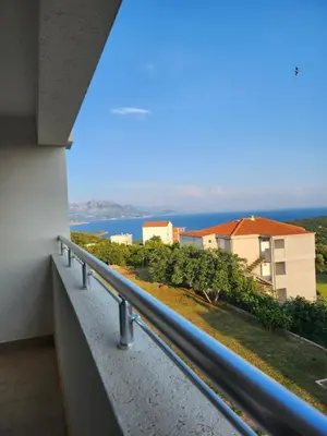 a view of the ocean from a balcony of a building at Apartments Wild Beauty - Krimovica in Budva