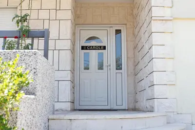 a door to a house with agraduate sign on it at Castelomi in Podgorica