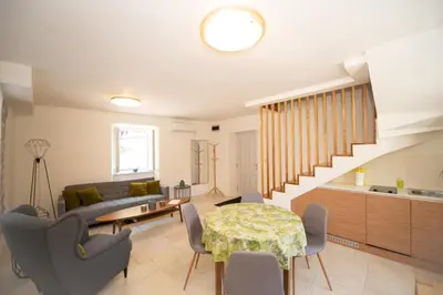 a living room with a table and a couch at Katareo Apartments in Kotor