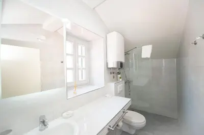 a white bathroom with a sink and a toilet at Katareo Apartments in Kotor
