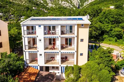 an aerial view of a building with solar panels on its roof at Apartments Venezia in Sutomore