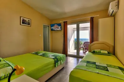 a bedroom with two beds and a view of the ocean at Apartments Venezia in Sutomore