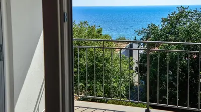 a balcony with a view of the ocean at Apartments Venezia in Sutomore