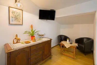 a room with a desk and a chair and a table at Astor apartments in Budva