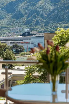 a vase on a table with a view of a city at Apartments Los Olivos in Kotor