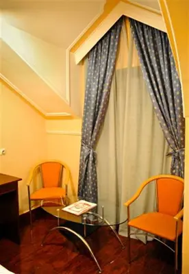 a room with two chairs and a table and a window at Hotel Evropa in Podgorica