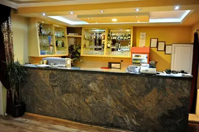 a bar in a restaurant with a counter top at Hotel Evropa in Podgorica