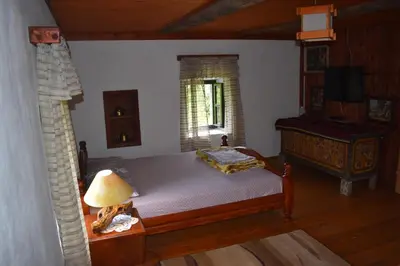 a bedroom with a bed and a table with a lamp at Old house Nilovic in Livari