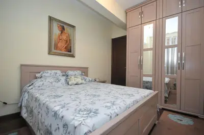 a bedroom with a bed and a painting on the wall at Lux Apartments MMS in Budva