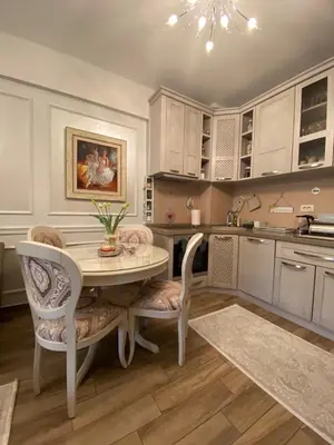 a kitchen with a table and chairs in a kitchen at Lux Apartments MMS in Budva