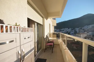 a balcony with chairs and a view of a city at Lux Apartments MMS in Budva