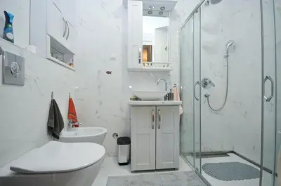 a bathroom with a shower and a toilet and a sink at Lux Apartments MMS in Budva