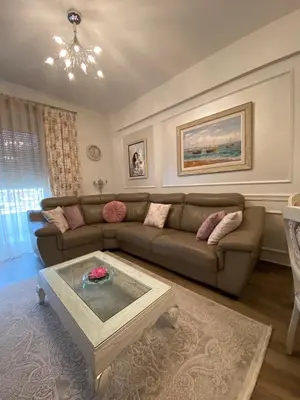 a living room with a couch and a coffee table at Lux Apartments MMS in Budva