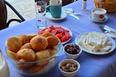 a table with a bowl of food on a table at Guest House Vera in Ulcinj