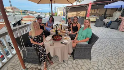 a group of people sitting at a table at Guest House Vera in Ulcinj