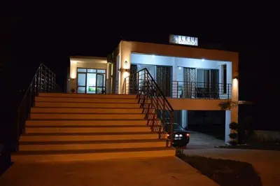 a house with stairs in front of it at night at Leli Apartments in Ulcinj