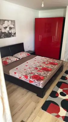 a bedroom with two beds and a red cabinet at Leli Apartments in Ulcinj
