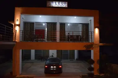 a car parked in front of a house at night at Leli Apartments in Ulcinj