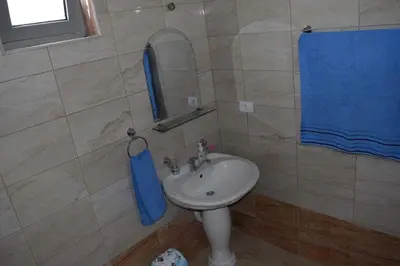 a bathroom with a sink and a mirror at Leli Apartments in Ulcinj