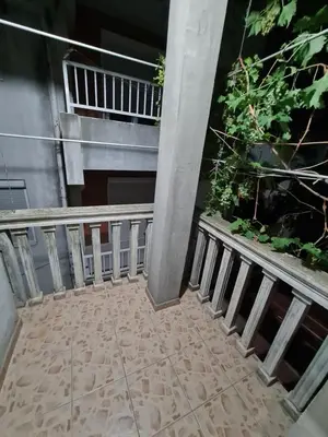 a balcony of a building with a plant at Apartmani Sanja in Bar