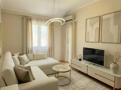 a living room with a couch and a tv at Aqua Mare Apartment in Budva