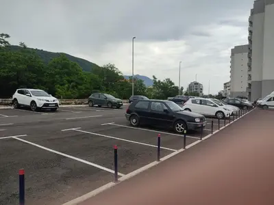 a bunch of cars parked in a parking lot at Aqua Mare Apartment in Budva