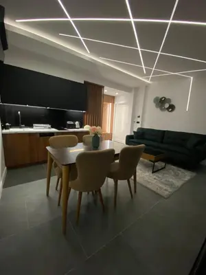 a living room with a dining room table and chairs at Apartments Dzaleta in Sveti Stefan