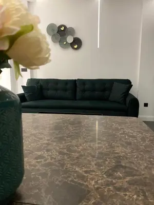 a living room with a couch and a glass table at Apartments Dzaleta in Sveti Stefan