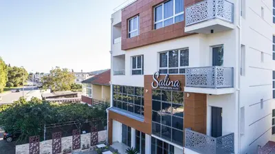 an apartment building with a sign on the side of it at Boutique Hotel 