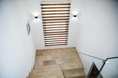 a staircase in a house with white walls at Boutique Hotel 