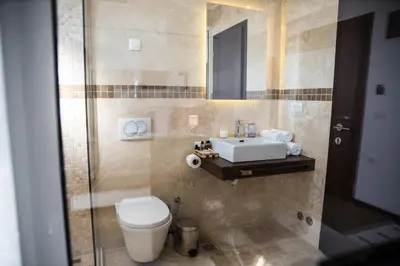 a bathroom with a toilet and a sink at Boutique Hotel 