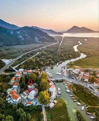 an aerial view of a river with houses and boats at Guesthouse Vukasevic in Virpazar