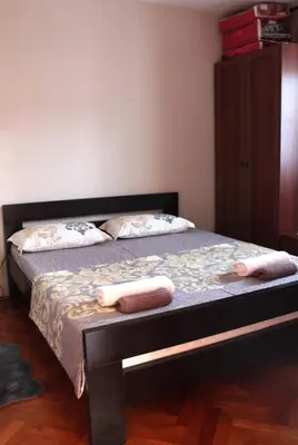 a bedroom with a bed with two towels on it at Holiday Home Gazevic in Virpazar