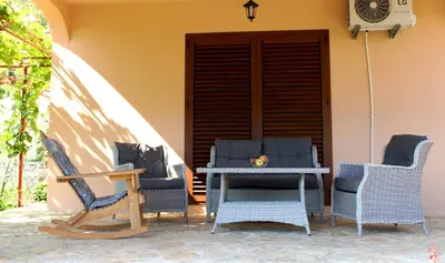 three chairs and a table on a patio at Holiday Home Gazevic in Virpazar