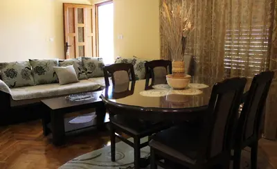 a living room with a table and chairs and a couch at Holiday Home Gazevic in Virpazar