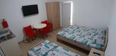 a bedroom with a bed and a table and chairs at Apartmani 