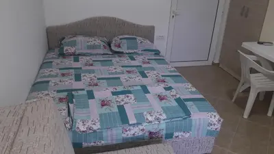 a bed with a quilt on it in a room at Apartmani 