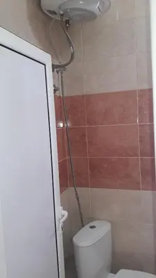 a bathroom with a toilet and a shower at Apartmani 